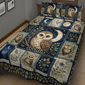 Close bedroom view of an owl quilt bedding set featuring a large owl, crescent moon, stars, and leafy branches