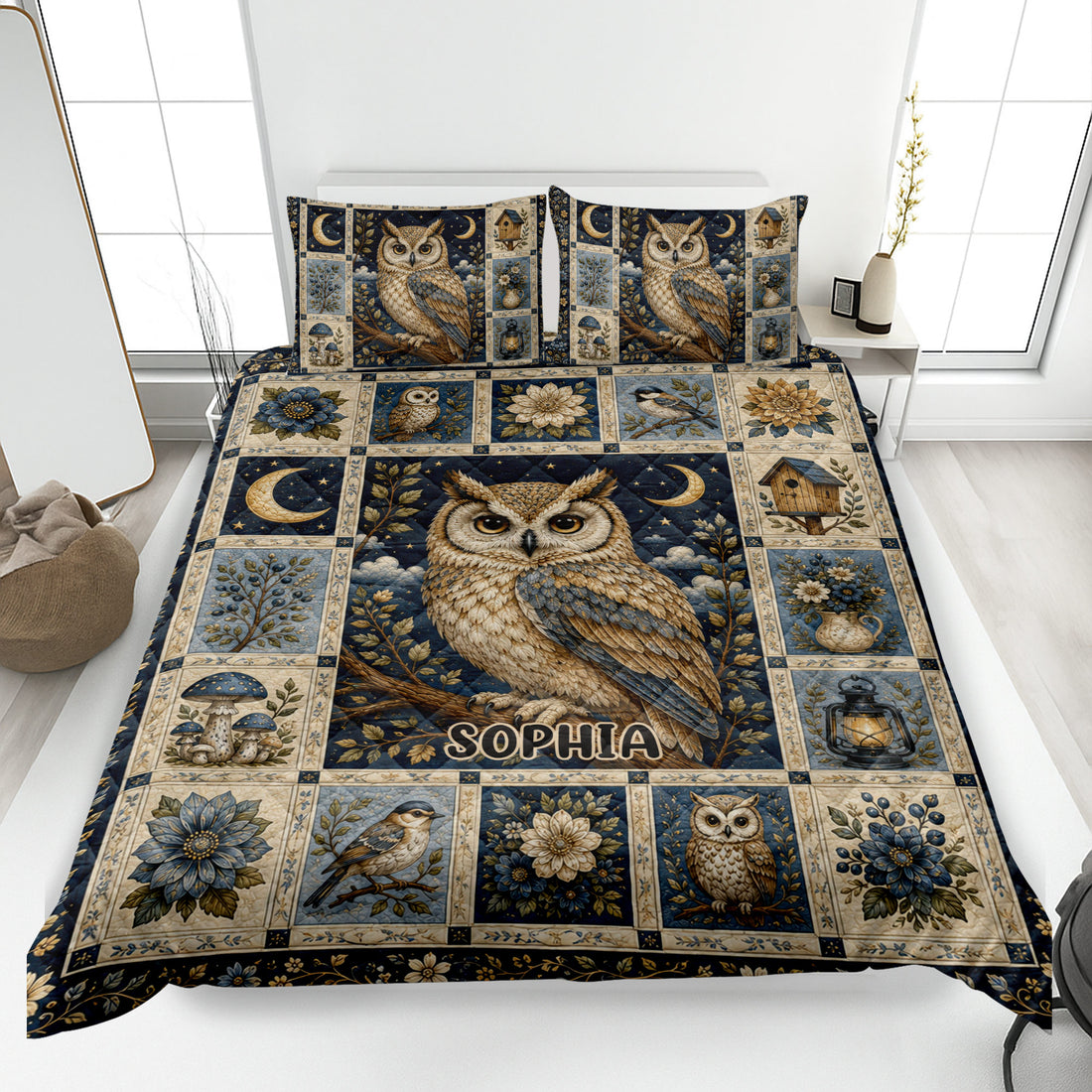 Owl quilt blanket displayed on a bed with moonlit birds, flowers, birdhouses, mushrooms, and navy botanical artwork