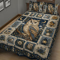 Close bedroom view of an owl quilt blanket with detailed owl artwork, flowers, lanterns, birdhouses, and deep blue tones