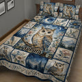 Close bedroom view of owl quilt blanket with celestial night sky, flowers, feathers, and mountain scenes
