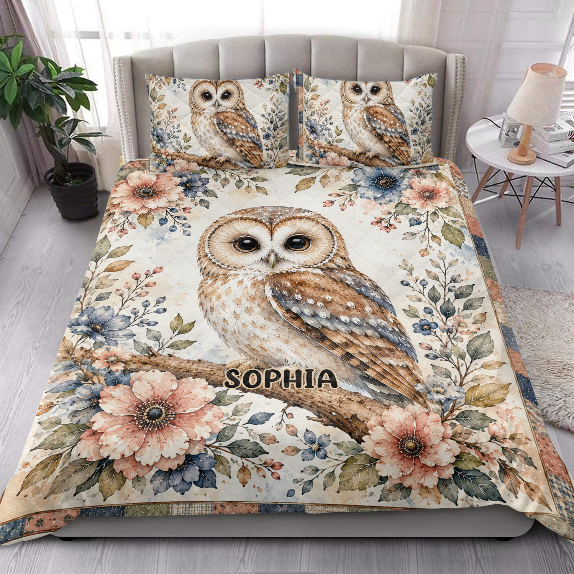 Owl quilt blanket styled on a bright bedroom bed with floral artwork and owl pillow designs