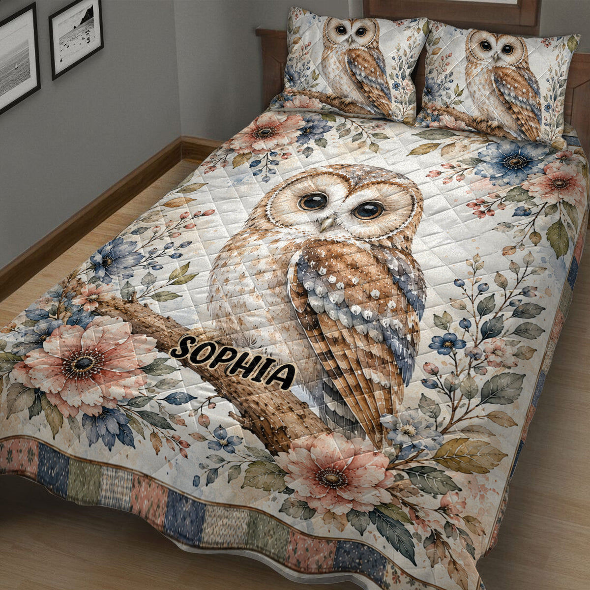Close view of a botanical owl quilt blanket with a large perched owl and colorful flowers
