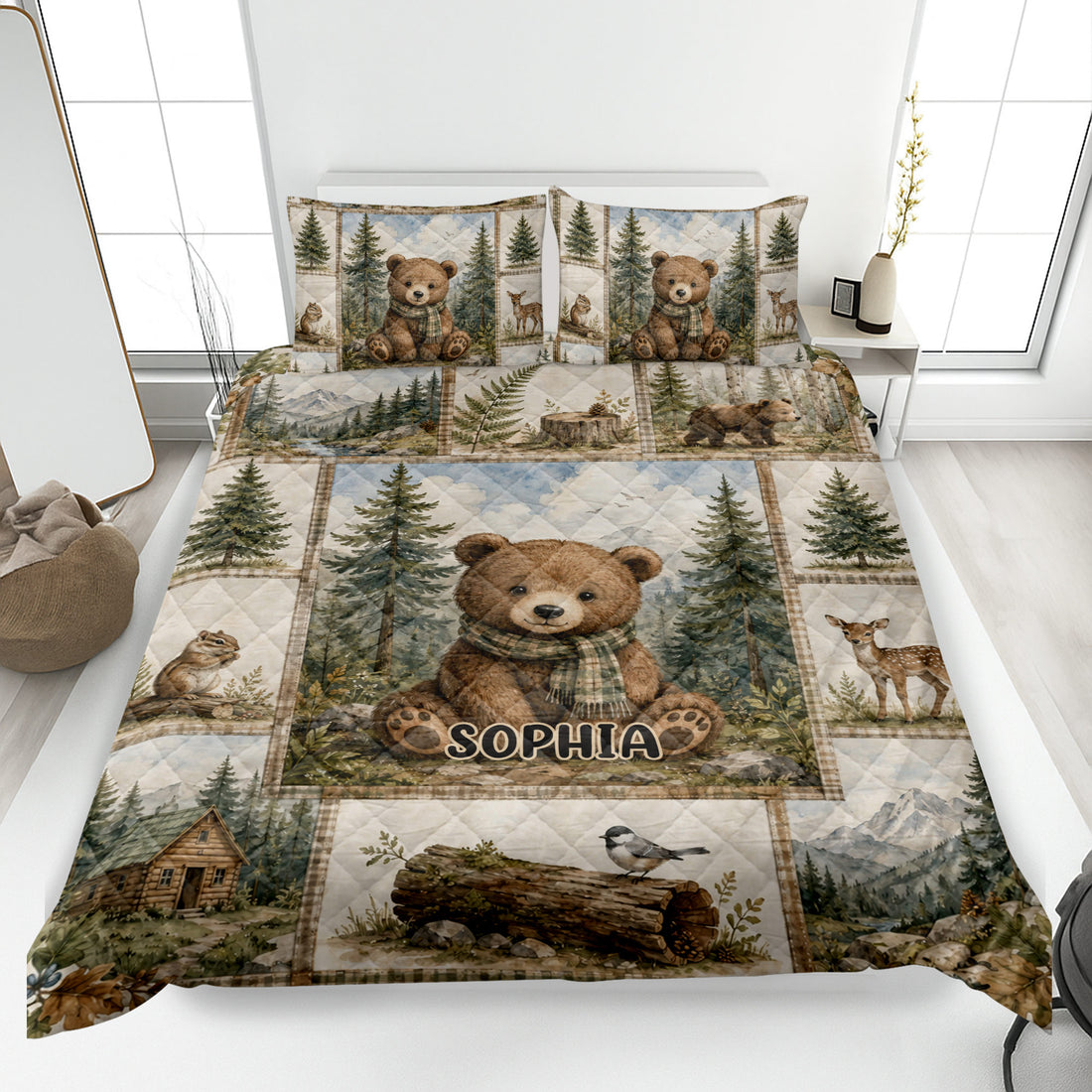 Bear quilt blanket spread across a bed with woodland scenes, pine trees, deer, and a cozy cabin