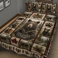 Close view of bear quilt bedding with detailed woodland scenes, cubs, pinecones, mountains, and rustic plaid borders