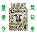 Dairy cow quilt bedding set shown flat with farmhouse artwork, wildflowers, barn scenes, and black-and-white cows