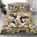 Dairy cow quilt blanket styled in a bright bedroom with daisy flowers, butterfly details, and farmhouse artwork