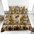 Bulldog quilt blanket spread on a bed with sunflower artwork and multiple illustrated bulldog portraits
