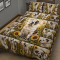 Close bedroom view of a bulldog quilt blanket featuring large portraits and sunflower meadow scenes