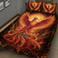 Close bedroom view of a fiery phoenix quilt blanket with ornate black and gold border details