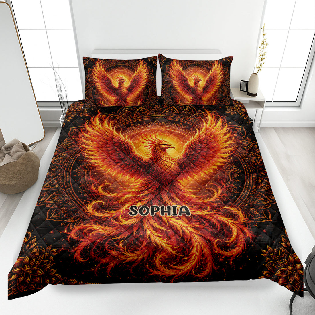 Phoenix quilt bedding set displayed on a bed with fiery orange and red artwork on a black background