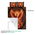 Phoenix quilt showing the vivid printed front and white quilted backing in a construction detail view