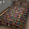 Colorful library bookshelf quilt blanket displayed across a bedroom bed