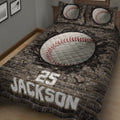 Close bedroom view of baseball quilt blanket with large stitched baseball artwork and rugged brick backdrop