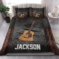 Acoustic guitar quilt blanket styled on a bright bedroom bed with matching guitar artwork on the pillowcases