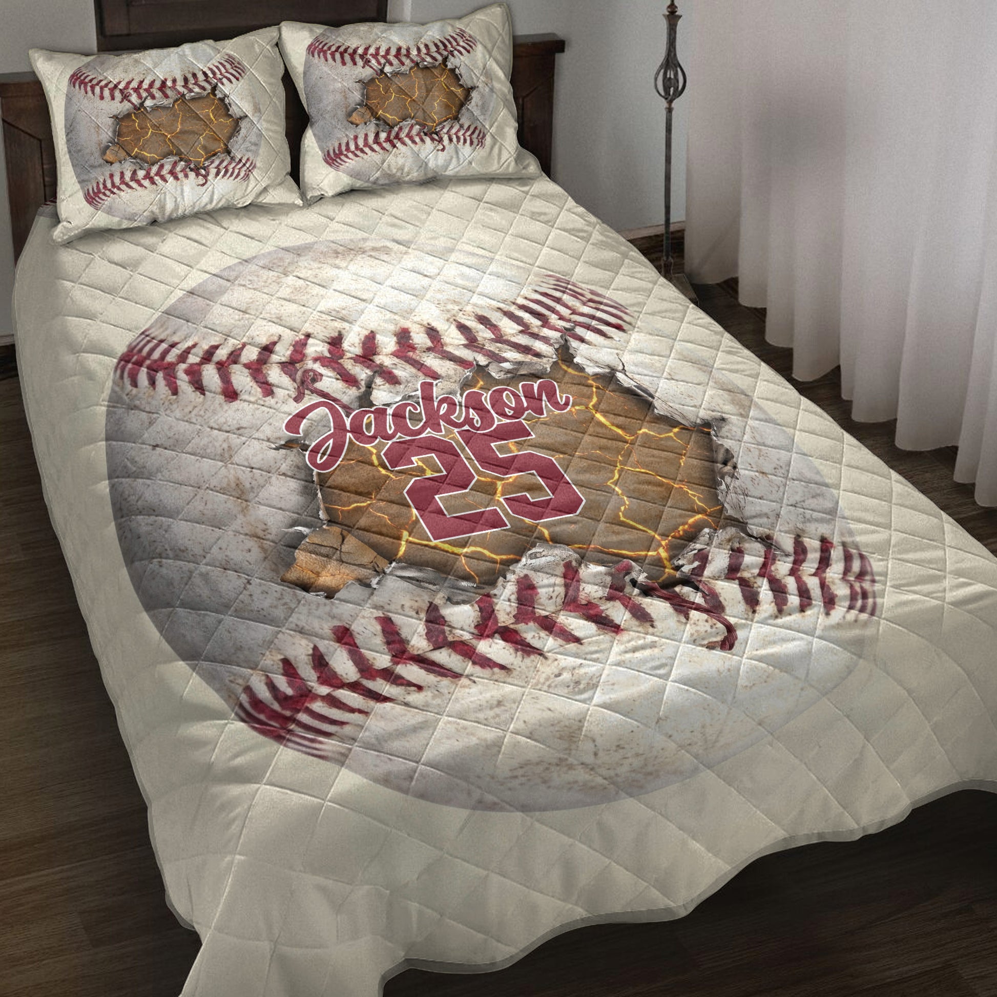 Baseball quilt blanket displayed on a bed with dramatic cracked-ball artwork in red, white, and gold