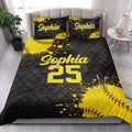 Black and yellow softball quilt blanket styled across a modern bedroom with coordinating pillows