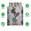 Autism quilt bedding set shown with colorful puzzle piece artwork and product feature icons around the bed