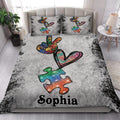 Autism quilt bedding styled in a bright bedroom with colorful puzzle pieces and heart artwork