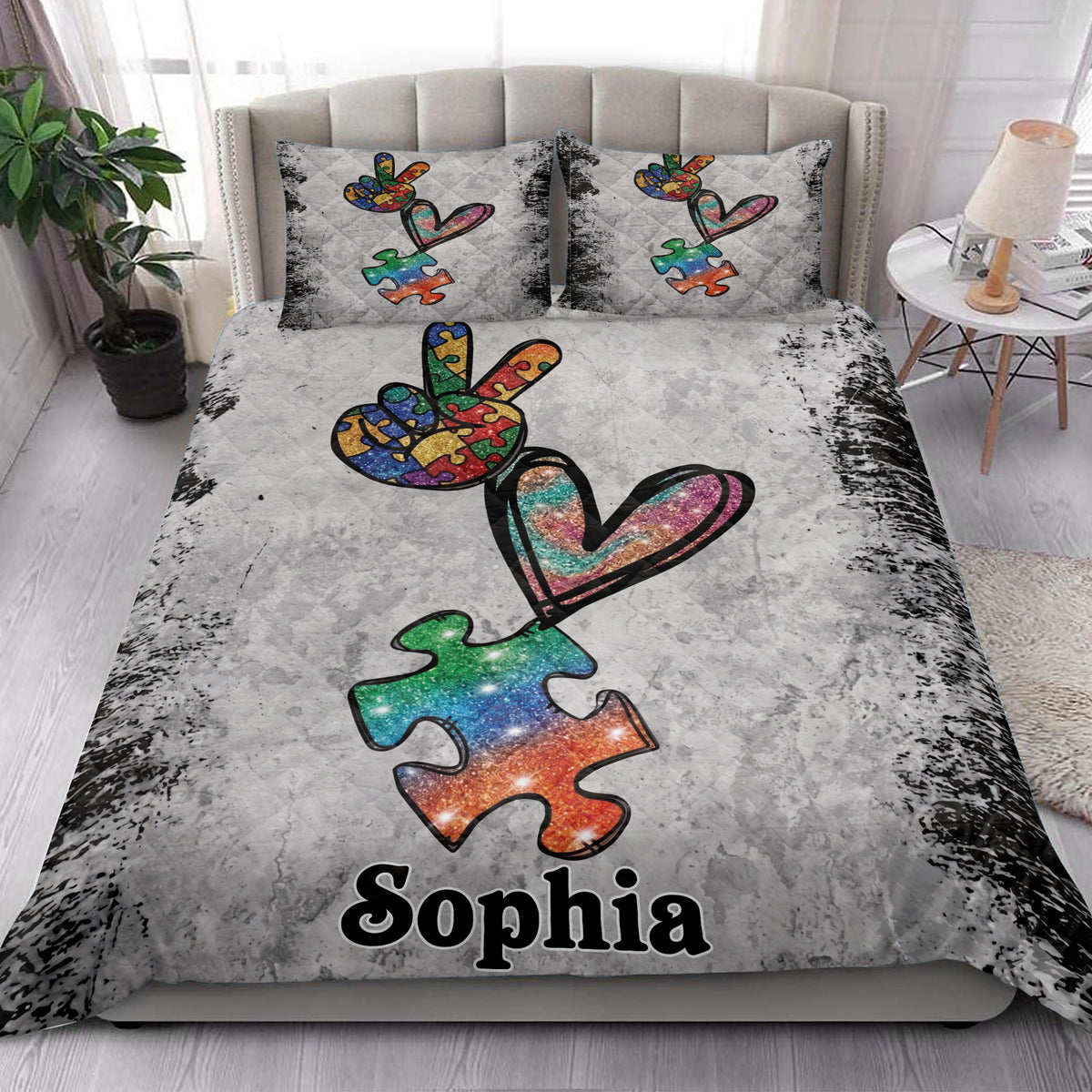Autism quilt bedding styled in a bright bedroom with colorful puzzle pieces and heart artwork