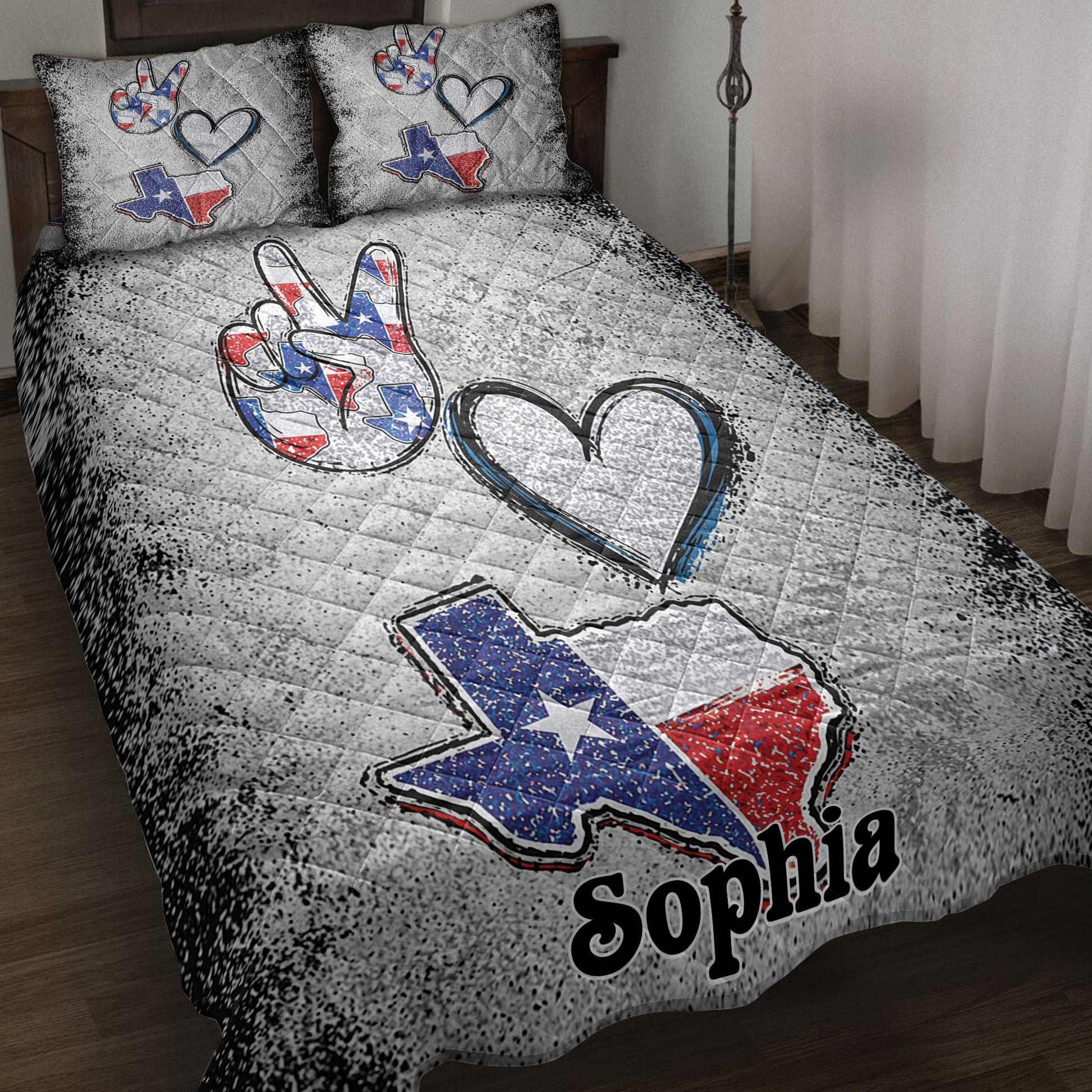 Texas quilt blanket on a bed with red, white, and blue Texas artwork, hearts, and a peace hand design