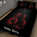 Close bedroom view of a black boxing quilt blanket featuring vivid red hanging gloves