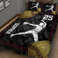 Softball player quilt blanket shown from an angled bedroom view with large softball graphics and a dramatic black, red, and gold design