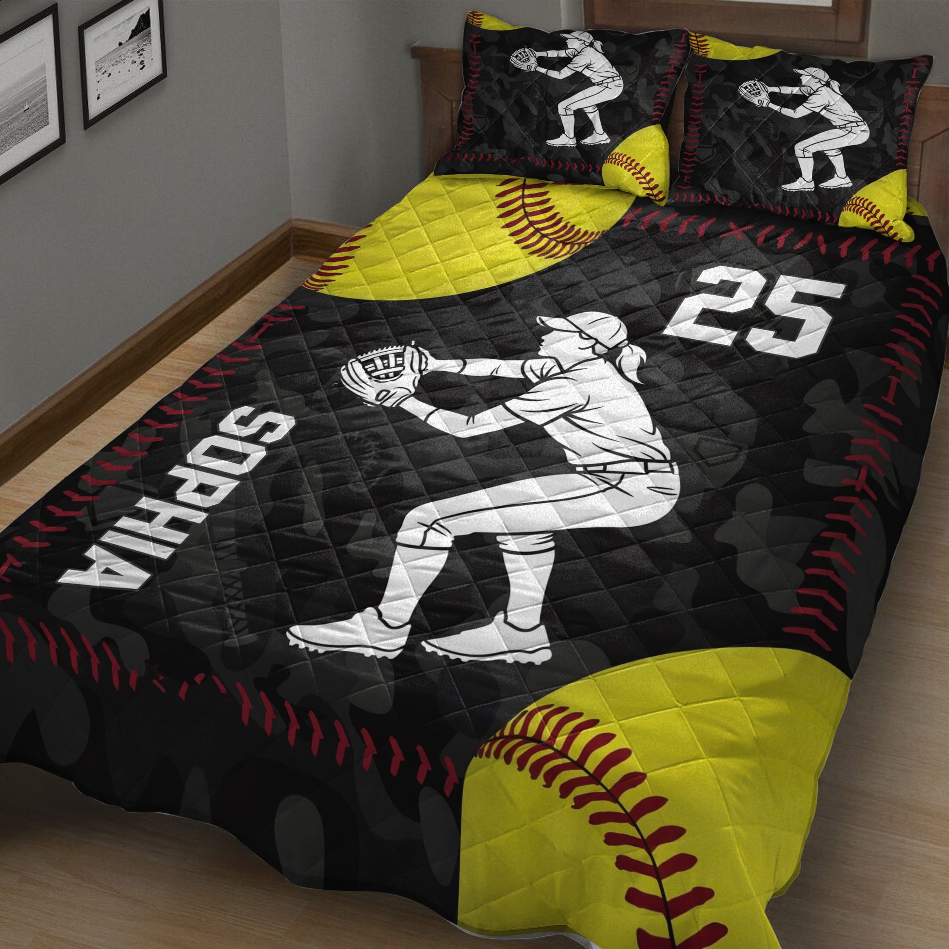 Black and yellow softball quilt blanket displayed on a bed with bold red stitching and player artwork