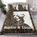 Deer quilt blanket styled in a bright bedroom with camouflage leaves, antlers, and white accents