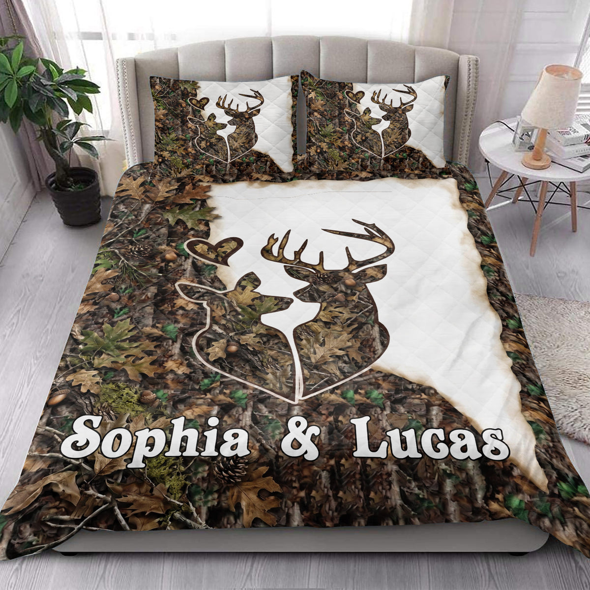 Deer quilt blanket styled in a bright bedroom with camouflage leaves, antlers, and white accents