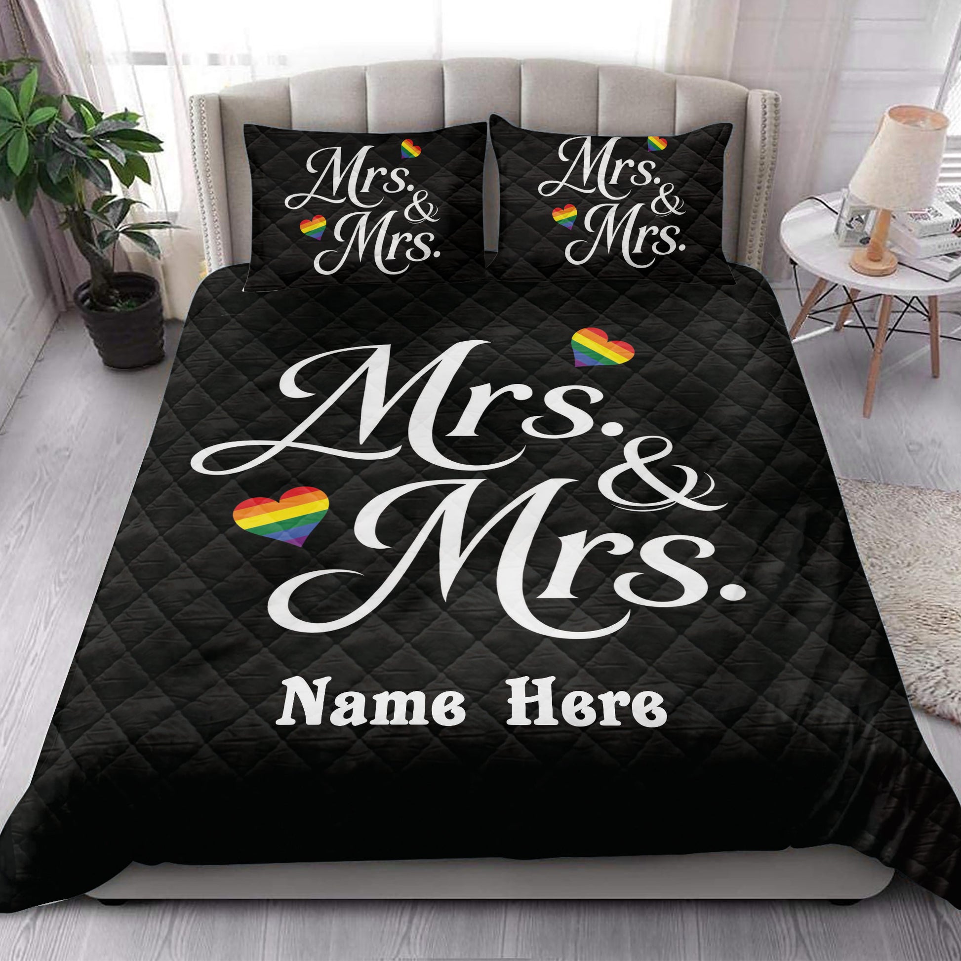 Black Mrs. and Mrs. LGBTQ+ quilt blanket styled in a bright bedroom with rainbow heart artwork