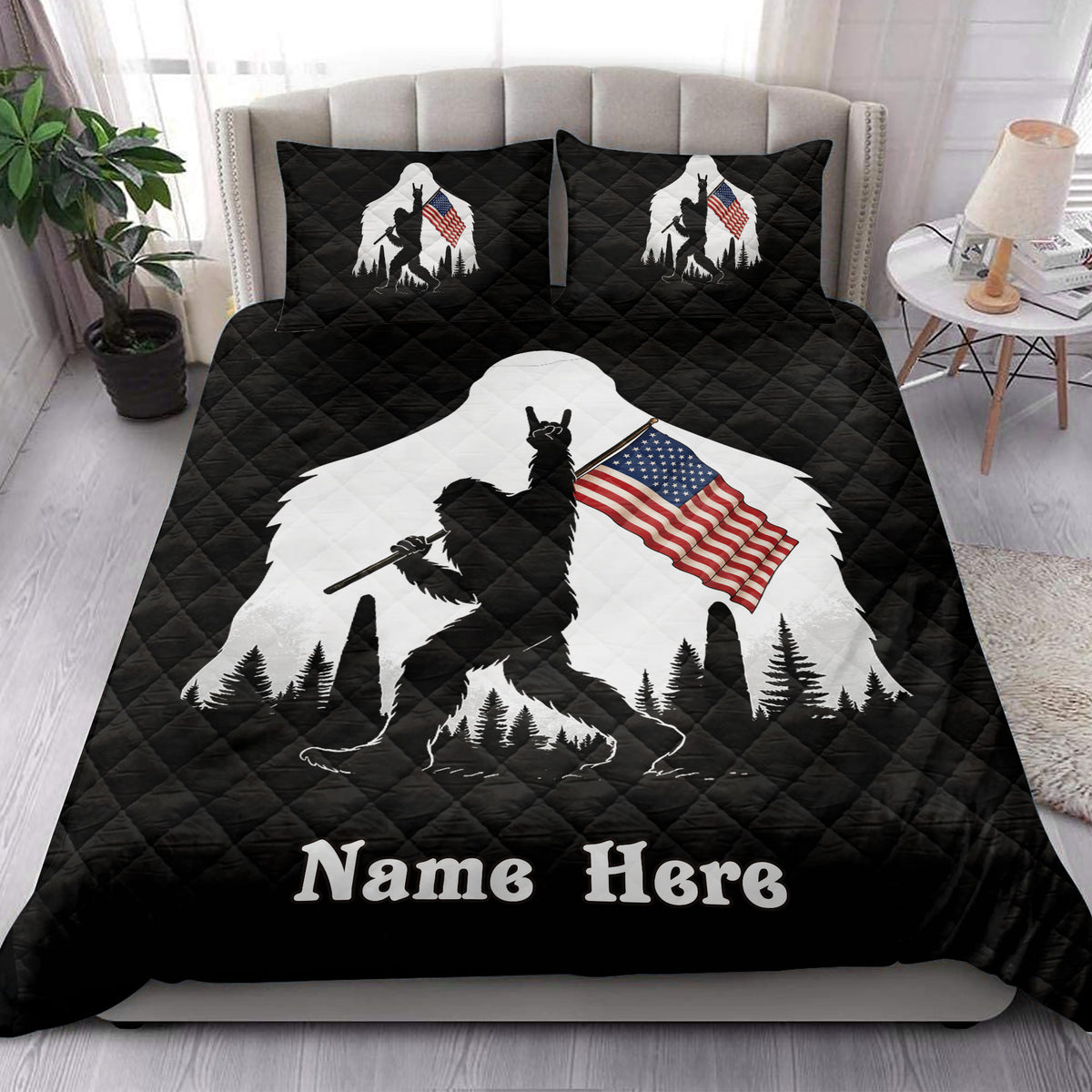 Bigfoot quilt bedding styled in a bedroom with black background, forest scenery, and American flag artwork