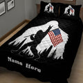 Close view of a black Bigfoot quilt blanket featuring woodland scenery and patriotic flag artwork