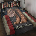 Cowboy quilt blanket on a bed with western boots, hat, stars, and rustic red, cream, and black accents