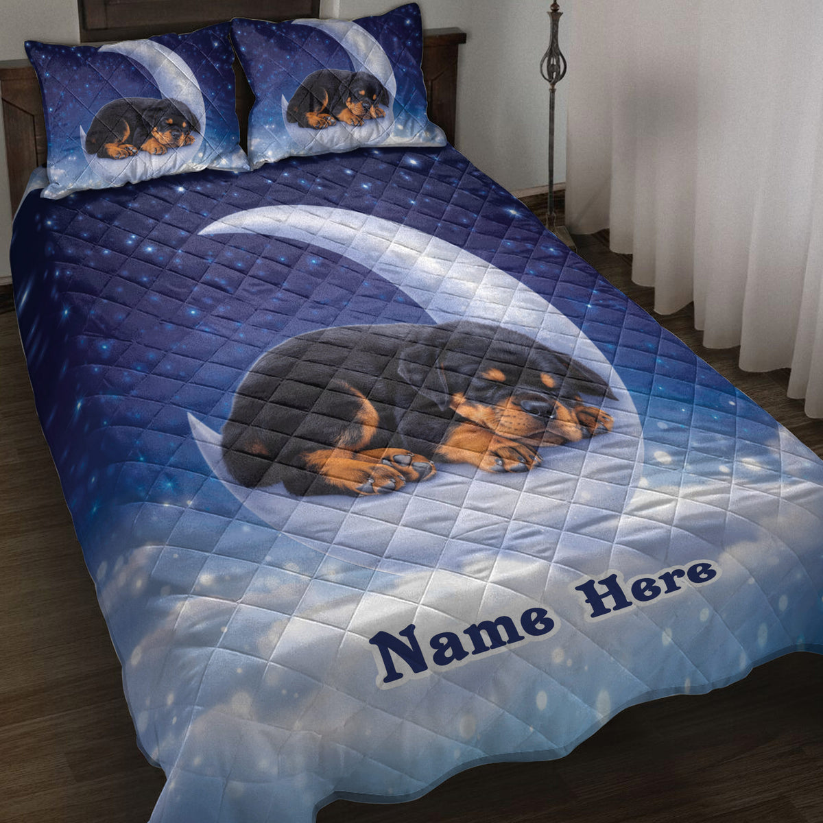 Rottweiler puppy quilt blanket displayed on a bed with a moonlit starry blue design