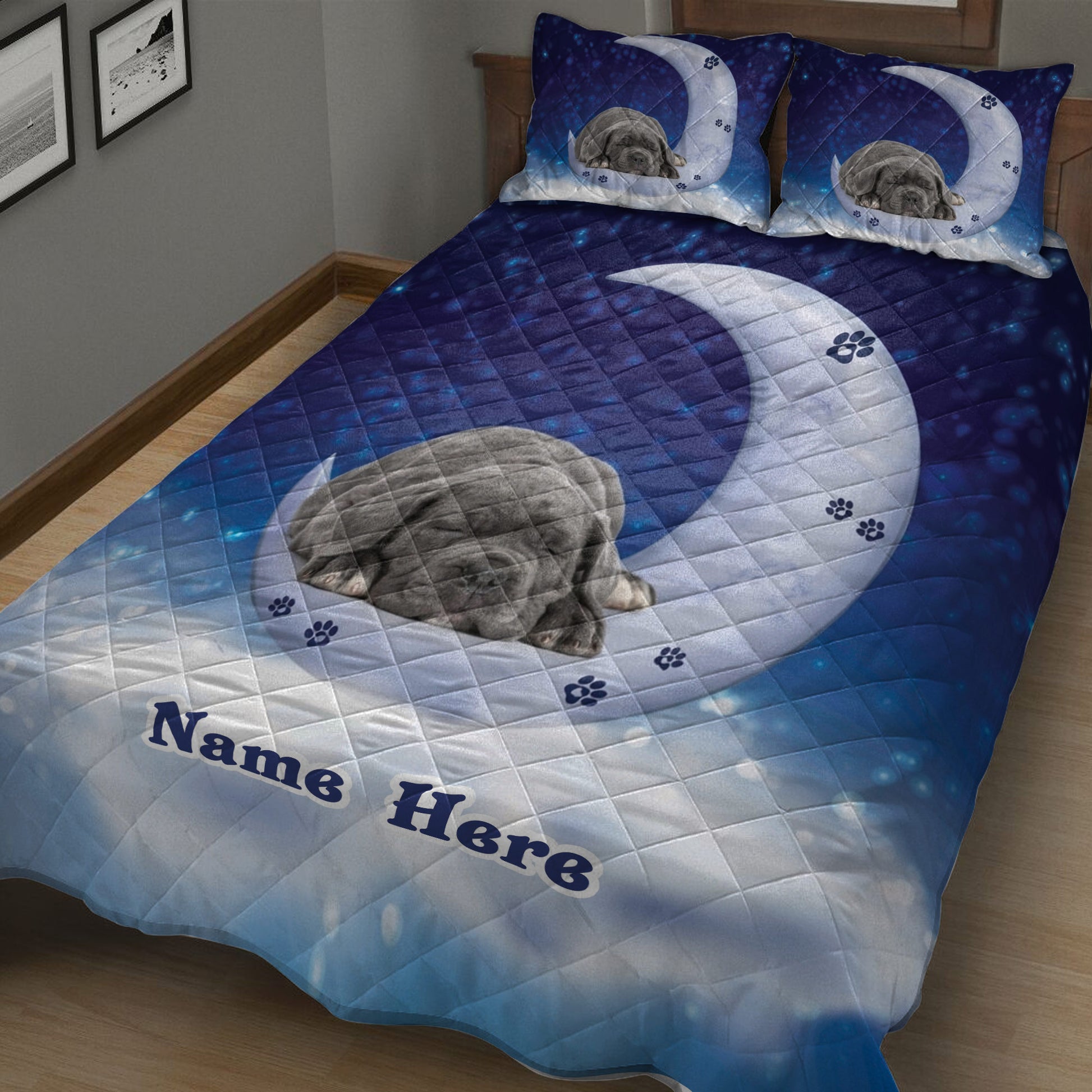 Close bedroom view of blue Cane Corso quilt bedding with sleeping dog and crescent moon artwork