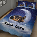 Angled bedroom view of a German Shepherd quilt blanket with sleeping puppy artwork, moon imagery, and blue stars