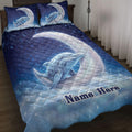 Blue dolphin quilt blanket displayed on a bed with moon, stars, bubbles, and matching pillow designs