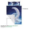 Dolphin quilt blanket showing its printed front and white quilted backing