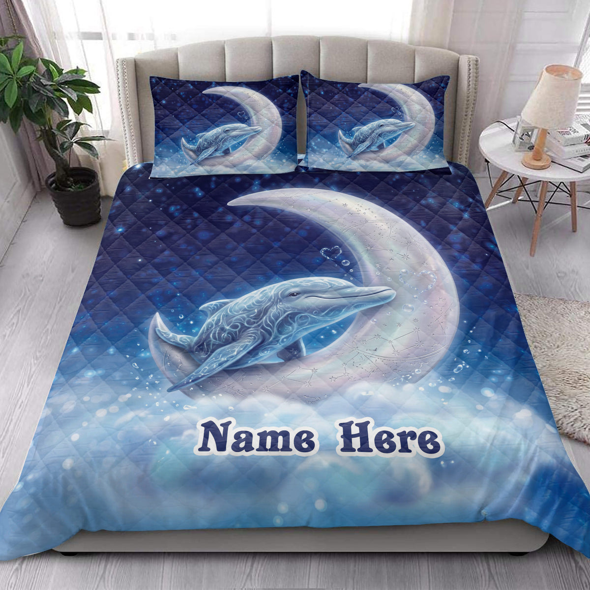 Dolphin quilt bedding styled in a bright bedroom with moonlit ocean artwork