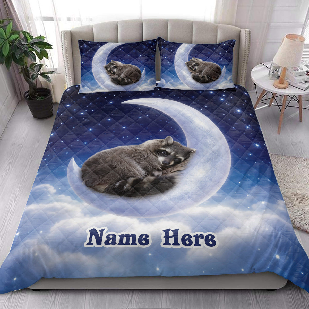 Raccoon quilt blanket styled on a bedroom bed with moon, clouds, stars, and nighttime artwork