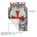 Knights Templar quilt blanket close-up showing the printed red cross design, quilted texture, and reverse side