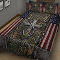 Close bedroom view of hunting quilt bedding with antlers, forest foliage, stars, and red striped borders