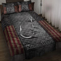Fishing quilt blanket displayed on a bed with silver hooks, dark quilting, stars, and patriotic red stripes