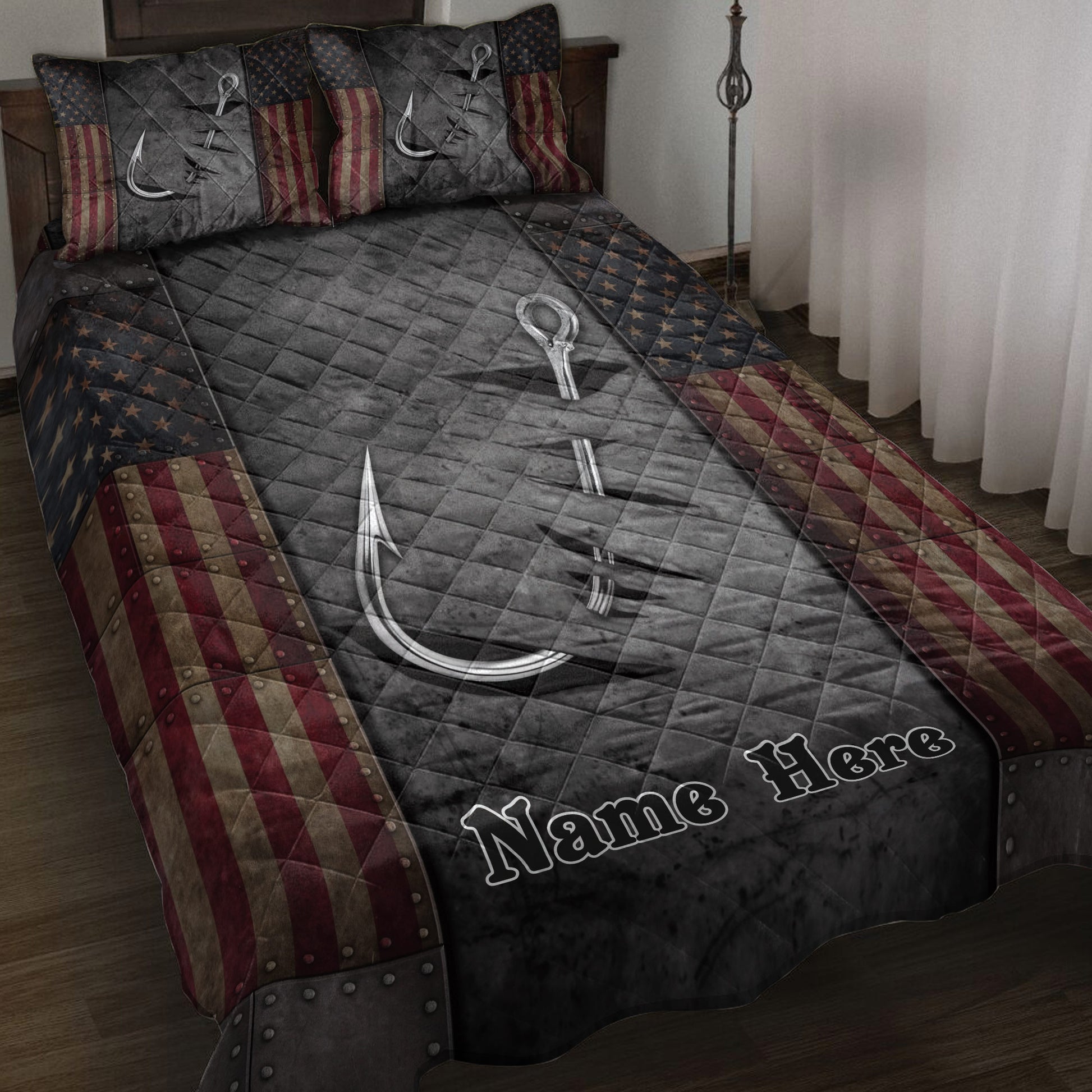 Fishing quilt blanket displayed on a bed with silver hooks, dark quilting, stars, and patriotic red stripes