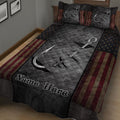 Angler-themed quilt blanket displayed on a bed with fishing hooks, dark textures, stars, and bold striped borders