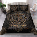 Christian cross quilt blanket displayed on a modern bed with matching cross artwork and black-gold decor