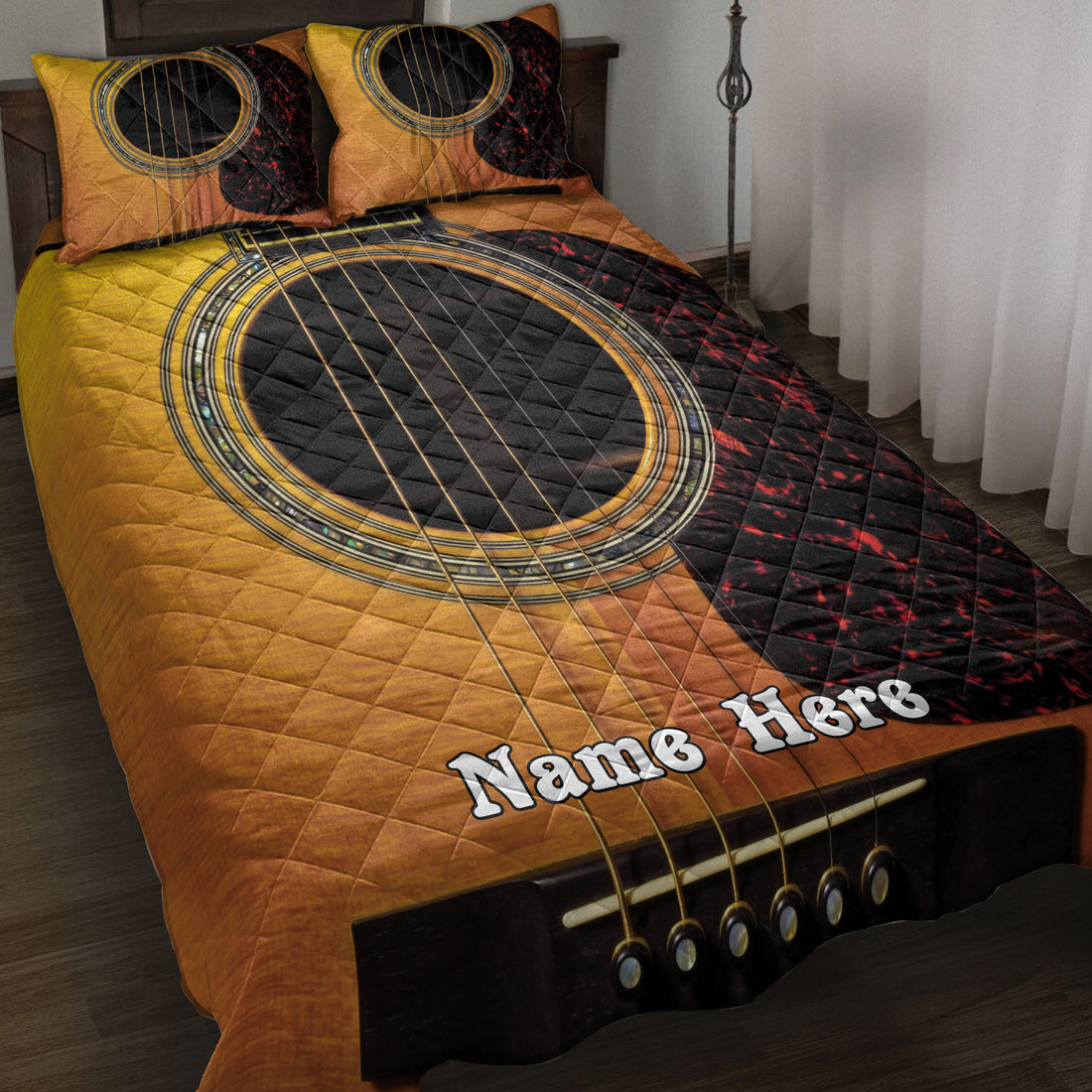 Acoustic guitar quilt blanket in gold, black, and red displayed across a bedroom bed