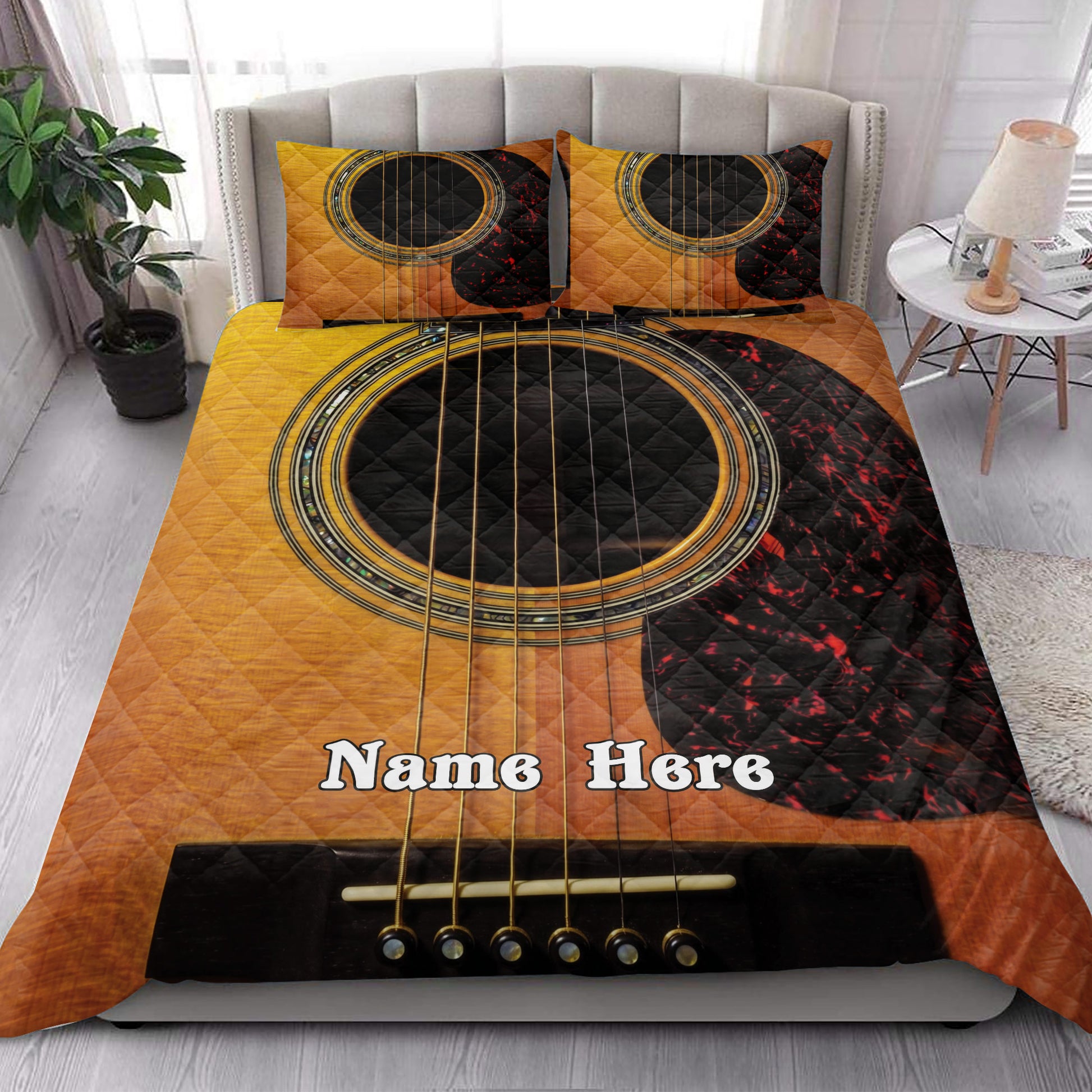 Acoustic guitar quilt blanket styled on a modern bedroom bed with matching pillow designs