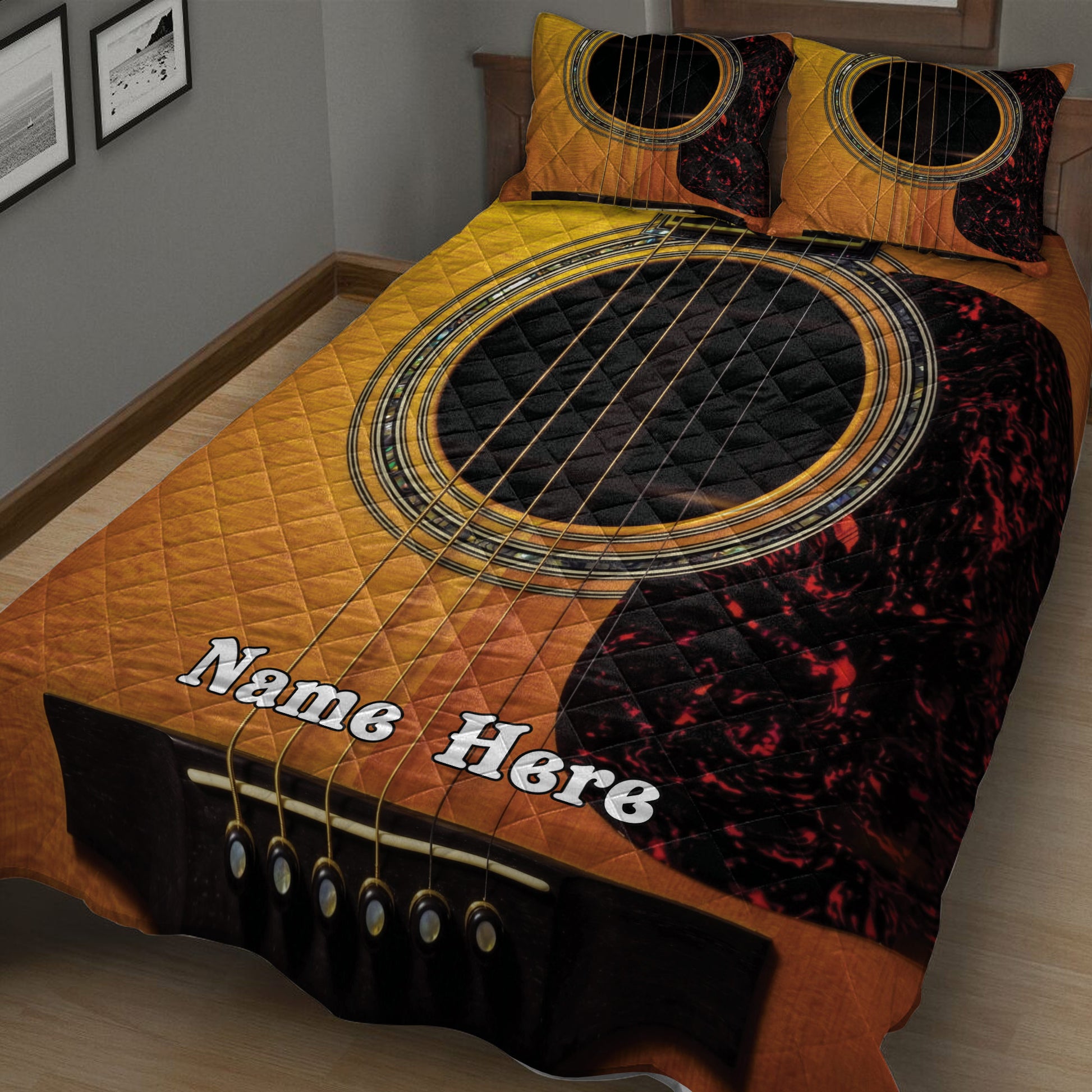 Close bedroom view of a dramatic gold, black, and red acoustic guitar quilt blanket