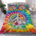 Bohemian hippie quilt blanket styled on a bed with bright tie-dye colors, peace symbol, and flowers